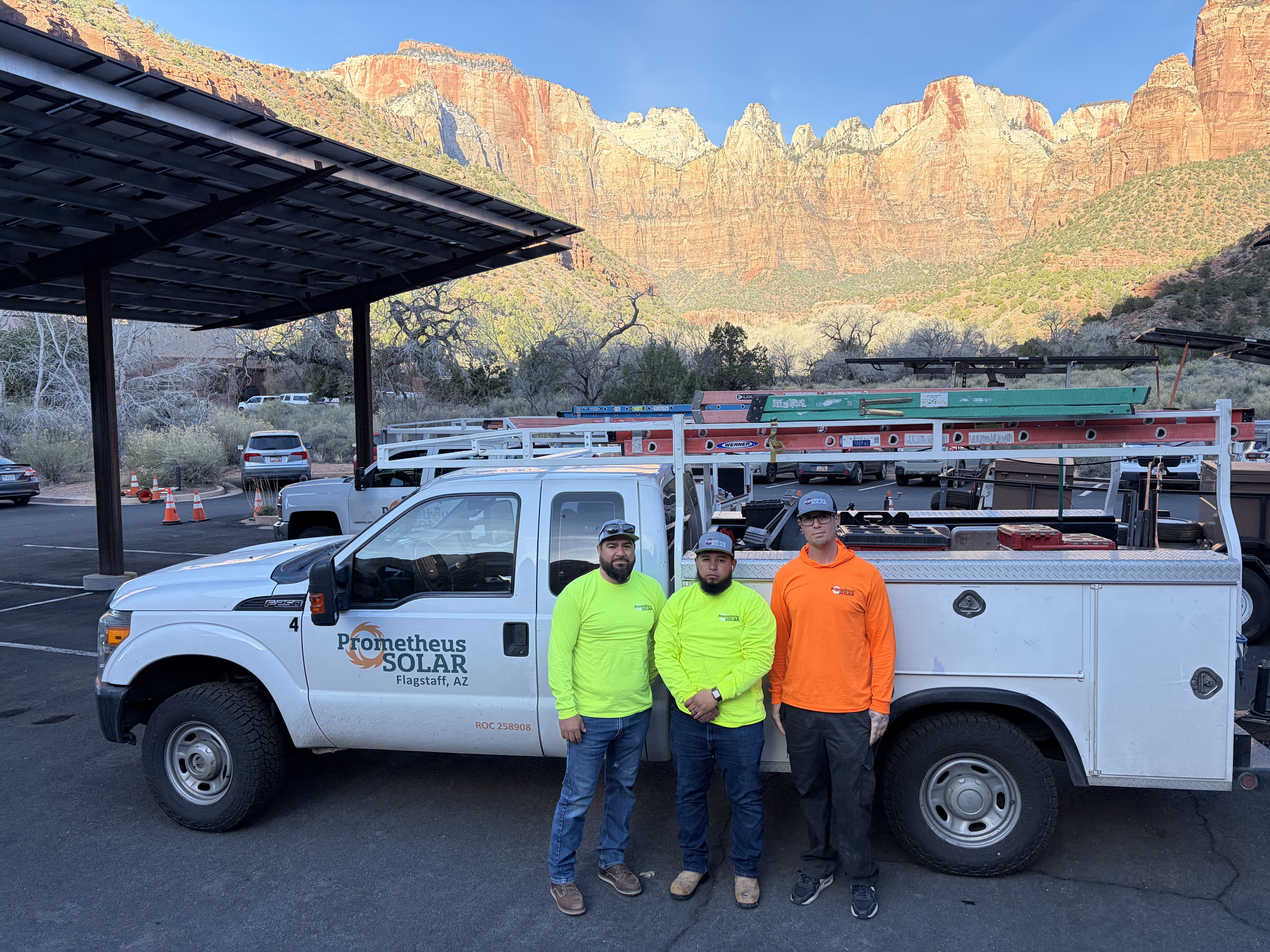Installers standing in front of truck with Solar material