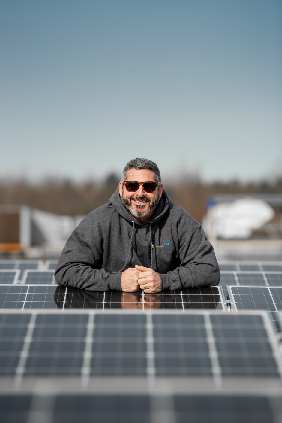 Scott on Roof with Panels_SUNationEnergy.jpg 