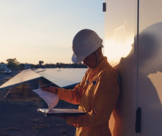 Installer looking at papers on sight