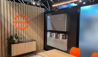 Enphase showroom with Enphase logo and IQ Battery on wall