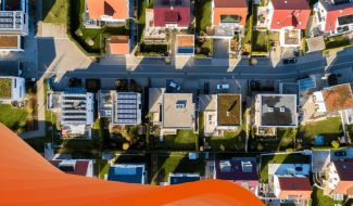 aerial shot of neighborhood with solar panels on roof