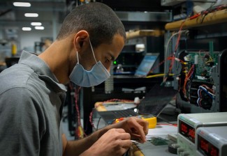 Enphase engineer in lab with mask on