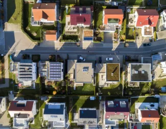 aerial shot of neighborhood with solar panels on roof