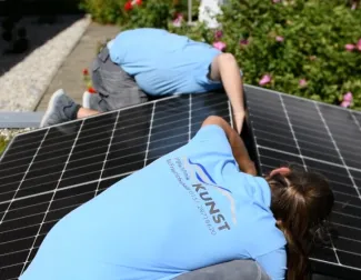 Solar installer on roof installing solar panels 