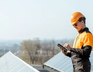 Installer on roof looking at phone
