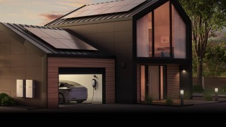 A contemporary house with solar panels on its roof, harnessing sustainable energy.
