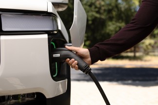 Man charging his car with Enphase EV charger
