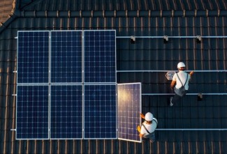 Solar Installers installing solar panels on the rooftop