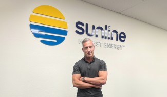 Matt Margolin standing proudly in front of the Sunline logo.
