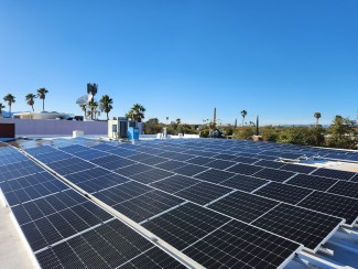 rows of solar panels with blue sky background