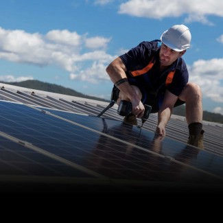 Enphase installer on roof installing solar panels