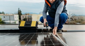 A worker carefully sets up a solar panel, highlighting the importance of solar energy in modern technology.
