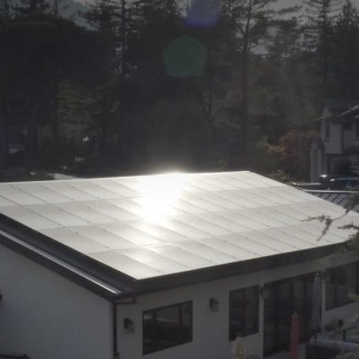 Photo of a house with sun on the roof