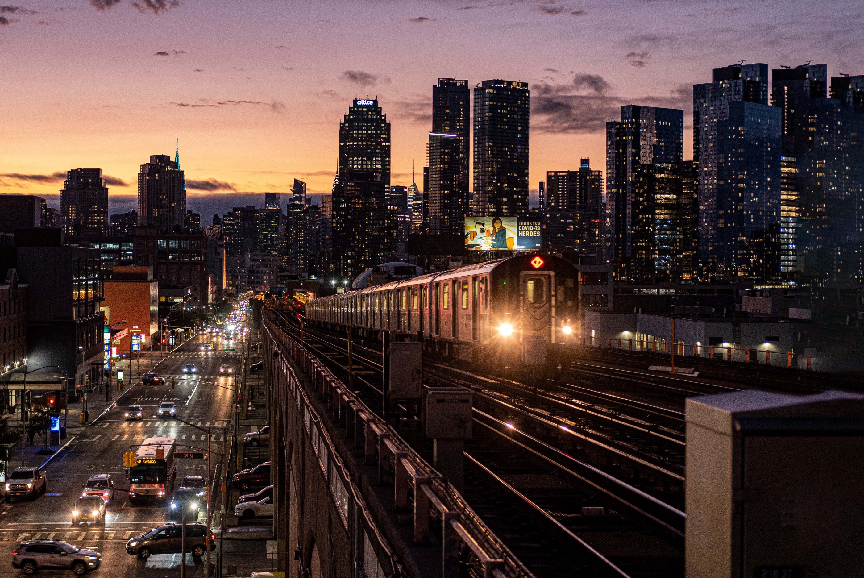 New York city train and skyline at sunset
